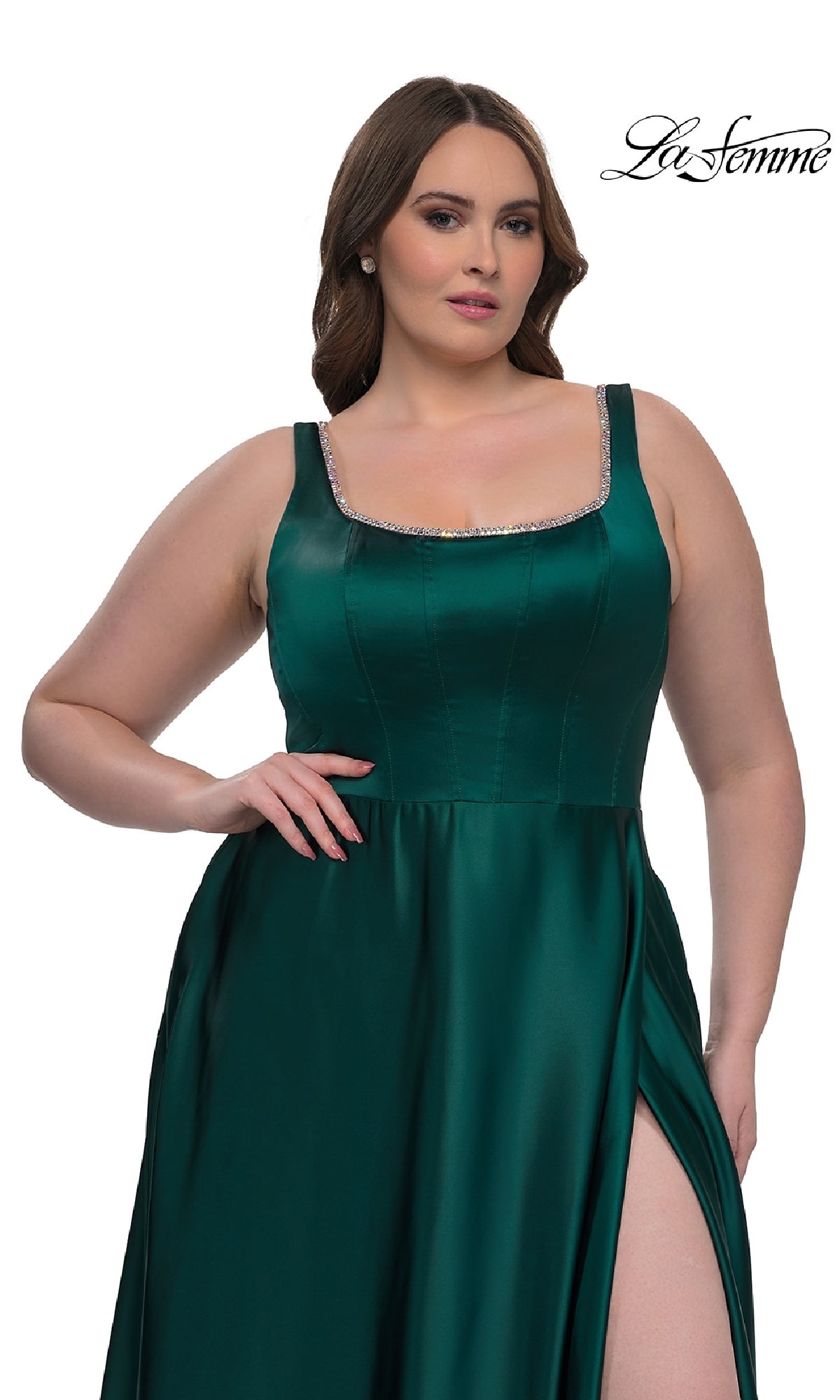 Plus-size woman wearing the La Femme 33026 classic long prom gown in emerald green satin with a jeweled neckline and thigh-high slit, posing against a white background.